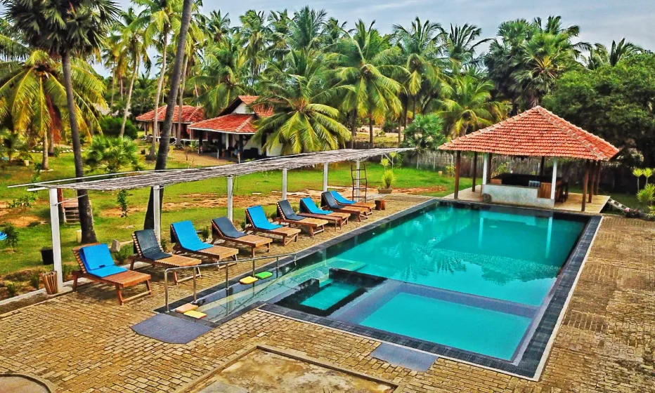 Aerial view of the pool and coconut garden at Valampuri Resort